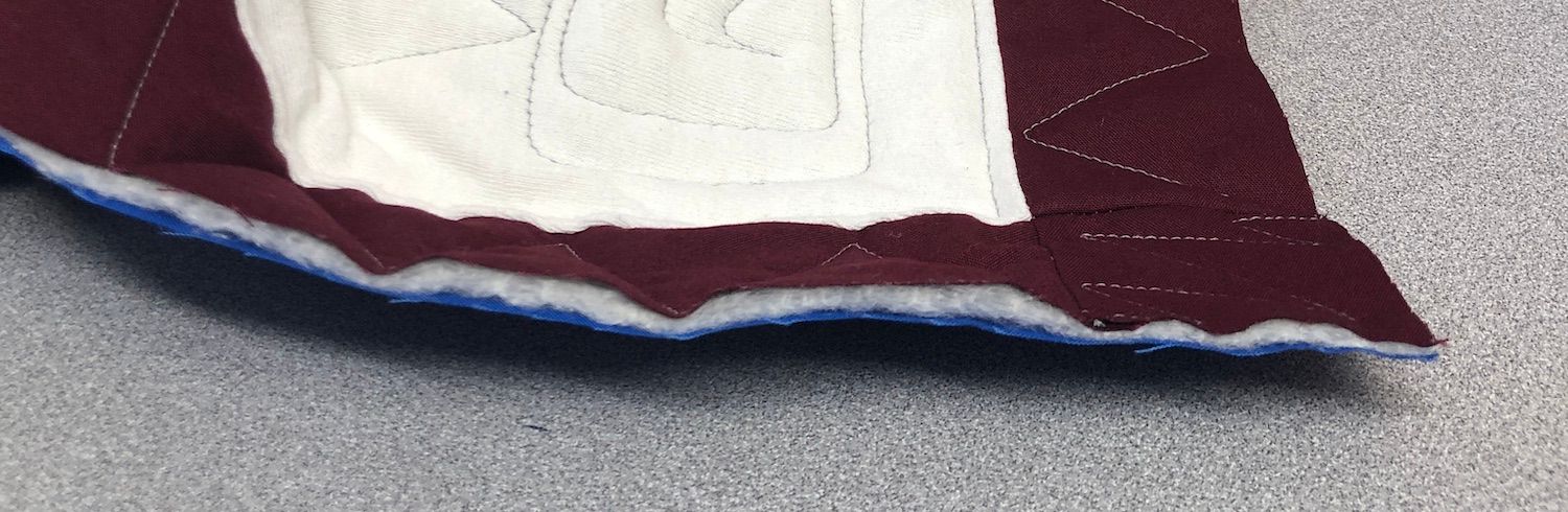 The raw edge of a quilt is what gets a binding added to it
