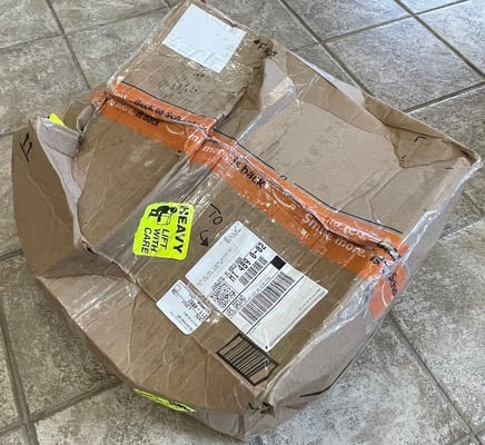 Crushed box of T-shirts that exploded on the way to the quilt maker.